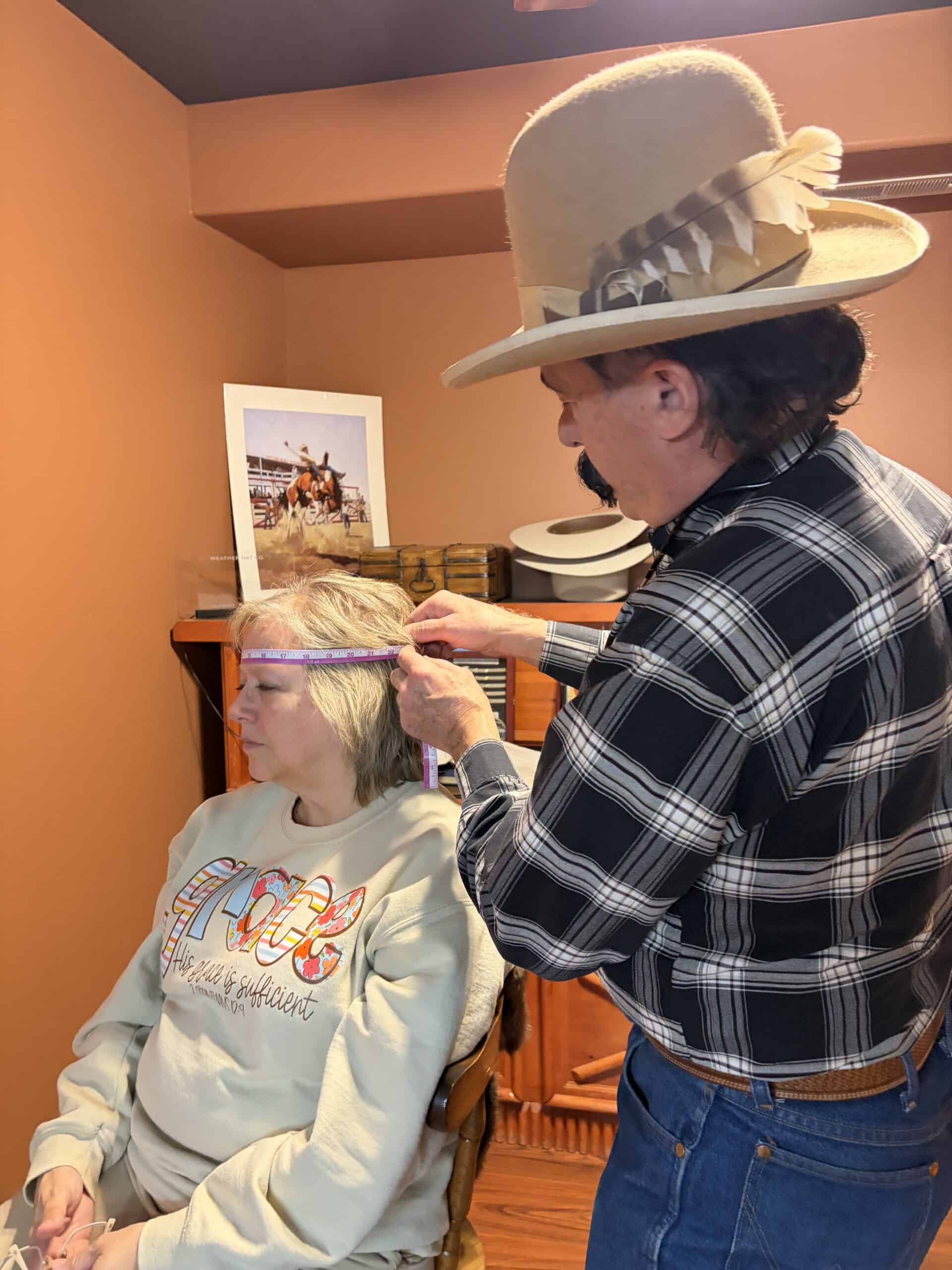 Jack measuring a head with a cloth tape measure showing measurements